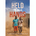 Book cover for 'Held in His Hands' by Anna Tikkvah, featuring two men walking in a dusty outdoor setting under a blue sky, with large title text overlaid across the top.